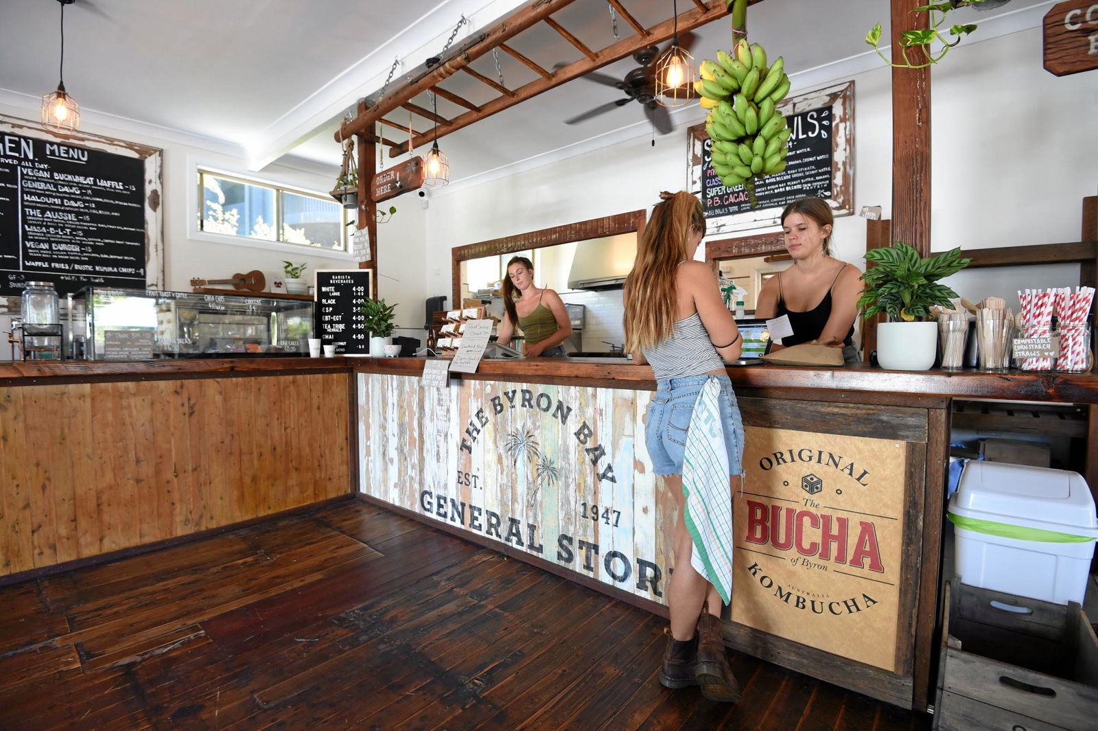 Woman taking coffee order from local cafe the Byron Bay General Store