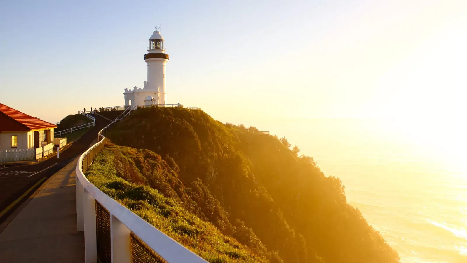 Byron Bay Lighthouse over with sunset shining from the west